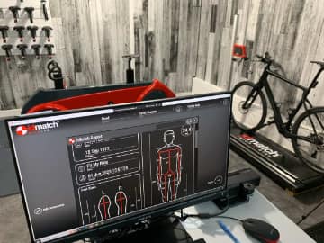 overview of studio with computer monitor, smart bike, and bike setup system in view.